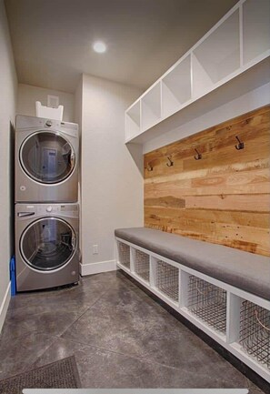 Convenient laundry facilities with two front-loading washing machines and storage for your essentials.