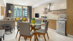 A modern apartment with a dining area, kitchen, and living space. - Spacious Studio Apartment on the Canals in CT (Cape Town)