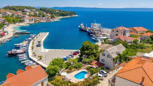 A coastal town with a marina, boats, and buildings with red-tiled roofs. - Villa Bonaca - Three Bedroom Villa, Sleeps 6 (Sumartin)