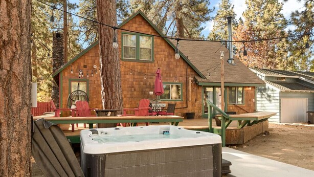 A rustic cabin with a hot tub, outdoor seating, and a chimney. - A rustic retreat nestled in the heart of Boulder Bay (Big Bear Lake)