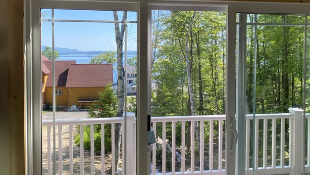 A view from a room with a glass door leading outside.