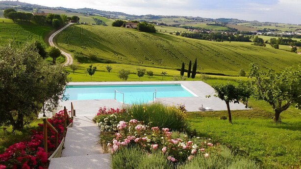 A pool with a view of rolling hills and a road in the background. - Ostra Villa - Sleeps 8 - Pool - Garden - Parking (Ostra)