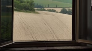 A window with a view of a rural landscape, including fields and distant hills. - Ostra Villa - Sleeps 8 - Pool - Garden - Parking (Ostra)