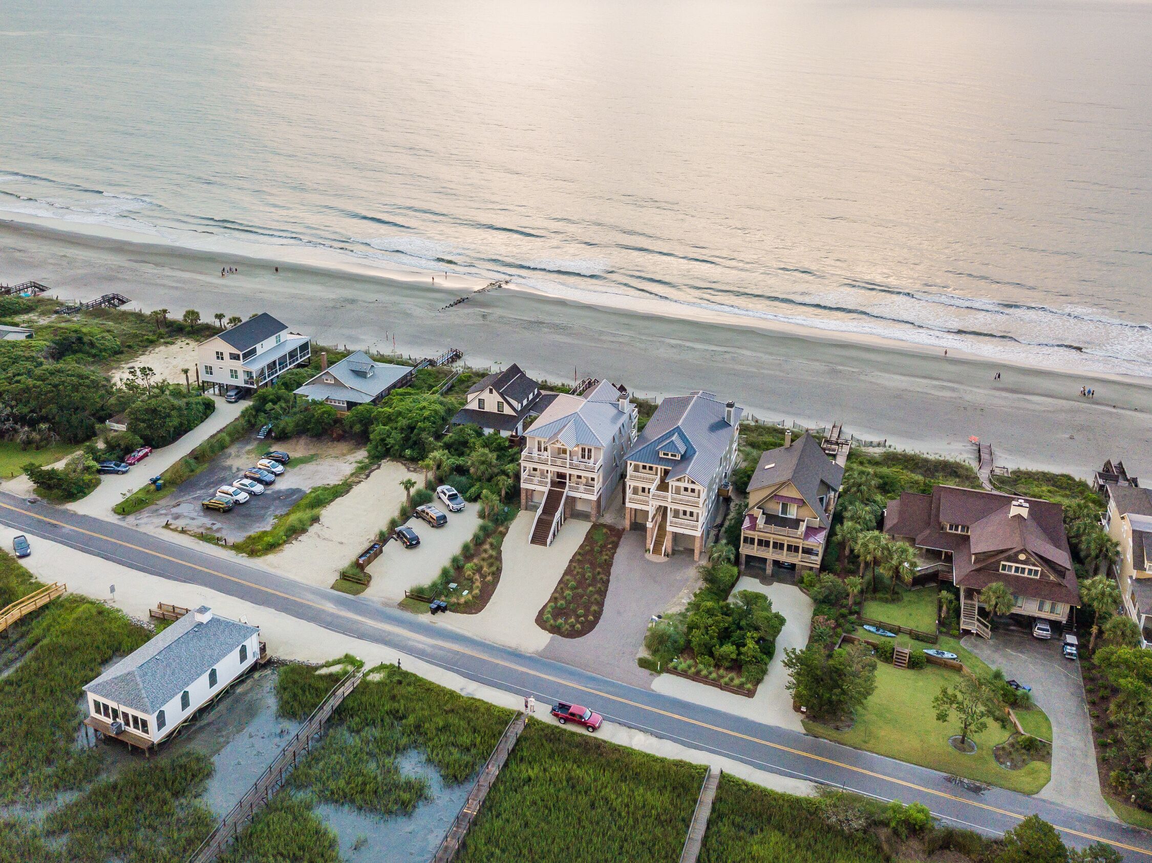 Zona residencial costera con casas, una playa y una carretera.
