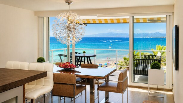 Un espace de restauration moderne offrant une vue sur la plage et l’océan.