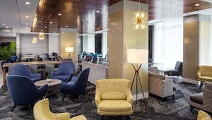 A modern lobby with seating areas, a reception desk, and a large window. - Holiday Inn Express Washington DC Downtown by IHG (Washington)
