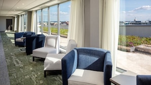 A hotel lobby with seating areas, large windows, and a view of the cityscape. - Holiday Inn Express Washington DC Downtown by IHG (Washington)