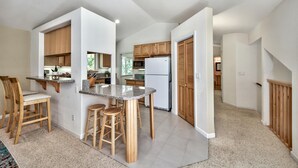 A modern kitchen with wooden cabinets, a granite countertop, and a built-in oven.