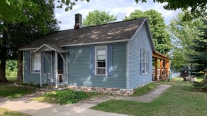 A single-story house with a stone foundation and a gabled roof. - Paul's Place - Two blocks from beaches in the heart of Grand Marais (Grand Marais)