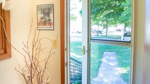 A door with a glass panel, a wooden frame, and a doormat. - Firefly House - Comforts of home across from beach/campground (Grand Marais)