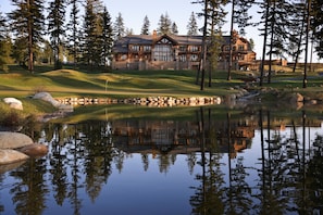 A large lodge with a reflection in a pond, surrounded by trees. - Suncadia Resort (Cle Elum)