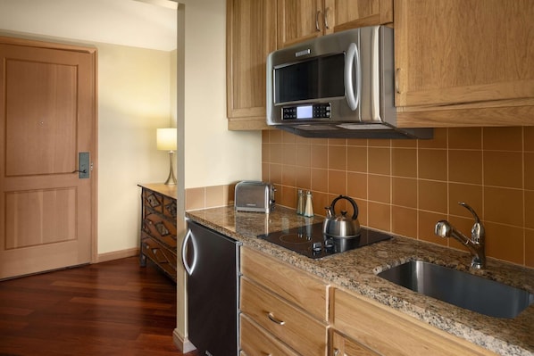 A kitchen with wooden cabinets, a stainless steel microwave, a sink, and a dishwasher. - Suncadia Resort (Cle Elum)