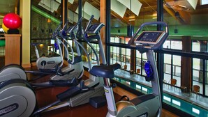 A gym with multiple treadmills, a red exercise ball, and a view of the outside through large windows. - Suncadia Resort (Cle Elum)
