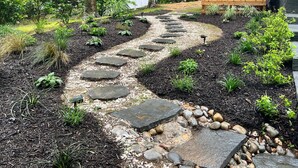 A garden pathway with stepping stones and a wooden fence. - Peaceful Beach Retreat in Southern Shores.Beach Front Parking Passes included (Kitty Hawk)