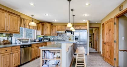 Ski-in/ski-out house with mountain view, gas fireplace, & wraparound deck