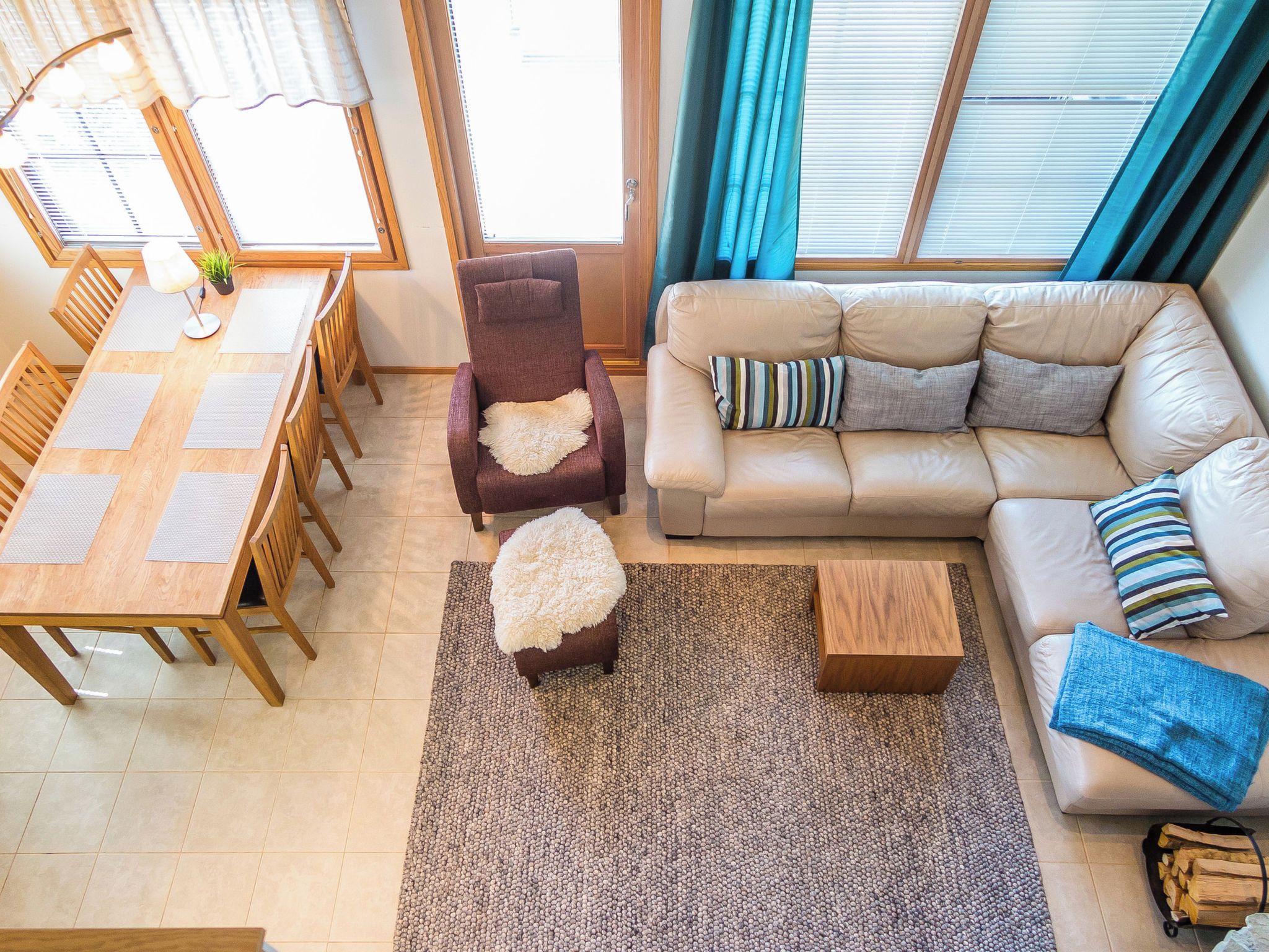 A living room with a sofa, armchairs, a coffee table, and a dining area with a table and chairs.