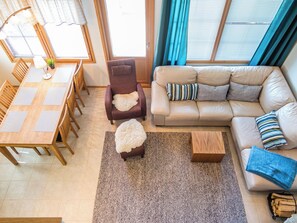A living room with a sofa, armchairs, a coffee table, and a dining area with a table and chairs. - Pike 2 as. 1 by Interhome (Nilsiä)