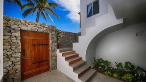 A stone wall, a wooden door, and a staircase with colorful steps. - Peace amid the Palms at La Isla Bonita Villa 2 (Sayulita)
