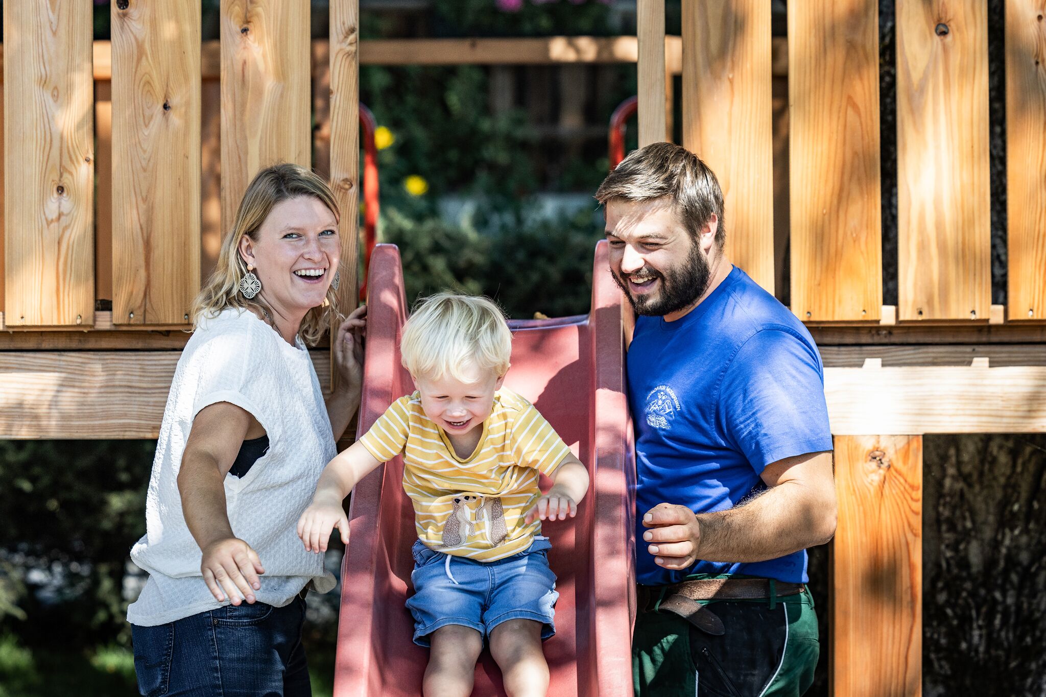A wooden play structure with a slide.