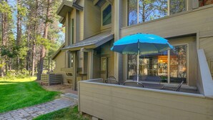 A modern house with a covered patio area, a number 36 sign, and a view of the interior through large windows. - Sunriver Family Escape with 6 SHARC Passes (Sunriver)