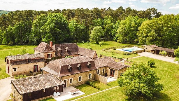 A large, rustic estate with multiple stone buildings, a swimming pool, and well-maintained lawns. - Charming villa with shared pool (Issac)