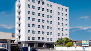 Ett hotell med flera våningar, en modern fasad, många fönster och en tydlig skylt högst upp.