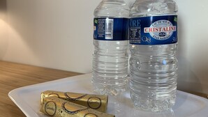 Two bottles of Cristaline water and a box of Gavottes on a white tray. - Simply Pinoche Room Proche Plage (Saint-Malo)