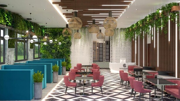 A modern interior with teal seating, a central round table, and vertical greenery. - Hotel Regal (Jabalpur)