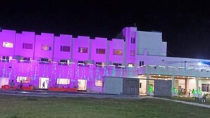 A multi-story building with a flat roof, illuminated by purple lighting. - Hotel Regal (Jabalpur)