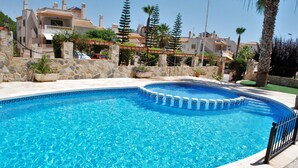 A swimming pool with a stone wall and a stone pathway leading to it. - Very nice apartment in 1st line of golf (VC)