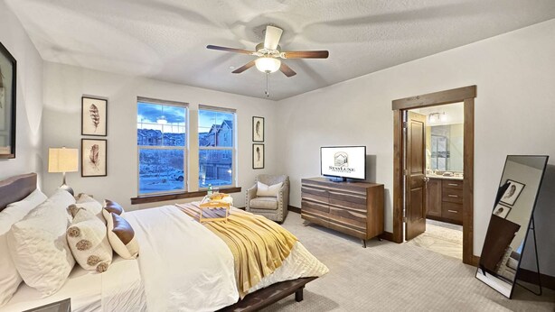 A bedroom with a bed, a dresser, a television, and a ceiling fan. - Fall Mountain Retreat•Hot Tub•BBQ•Community Amenities•Uinta Foothill Views (Heber City)