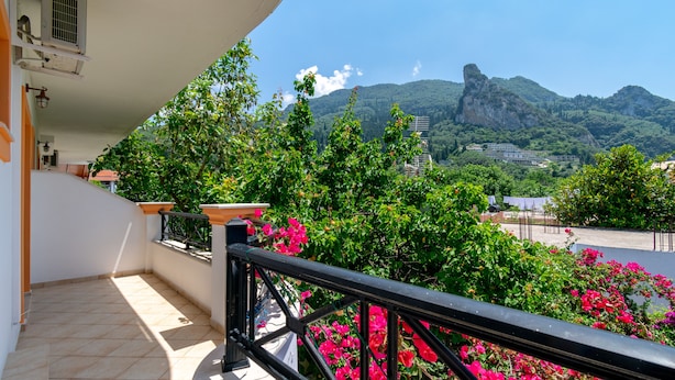 A balcony with a view of mountains and greenery. - Villa Sophia by CorfuEscapes (Corfu)