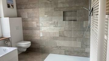 Bathtub, towels, soap, toilet paper