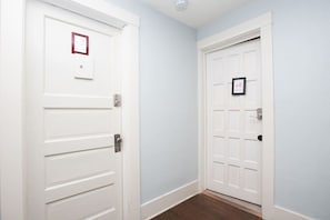 A hallway with two white doors, each marked with a number.