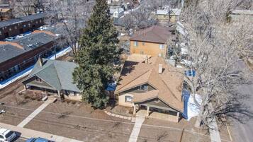 An aerial view of a residential area with a two-story house, a garage, and a driveway.