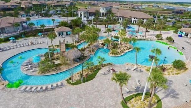 A resort with multiple swimming pools, palm trees, and lounge areas.