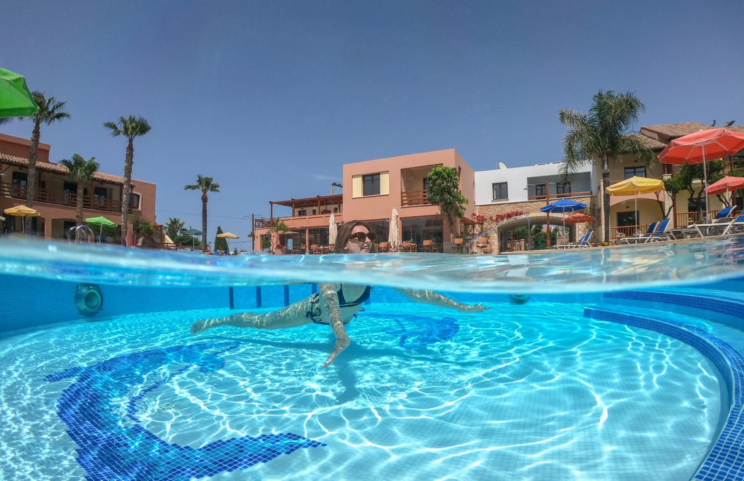 Seasonal outdoor pool, open 10:00 AM to 6:30 PM, pool umbrellas