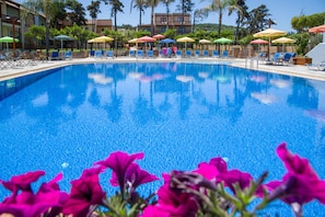 Seasonal outdoor pool, open 10:00 AM to 6:30 PM, pool umbrellas