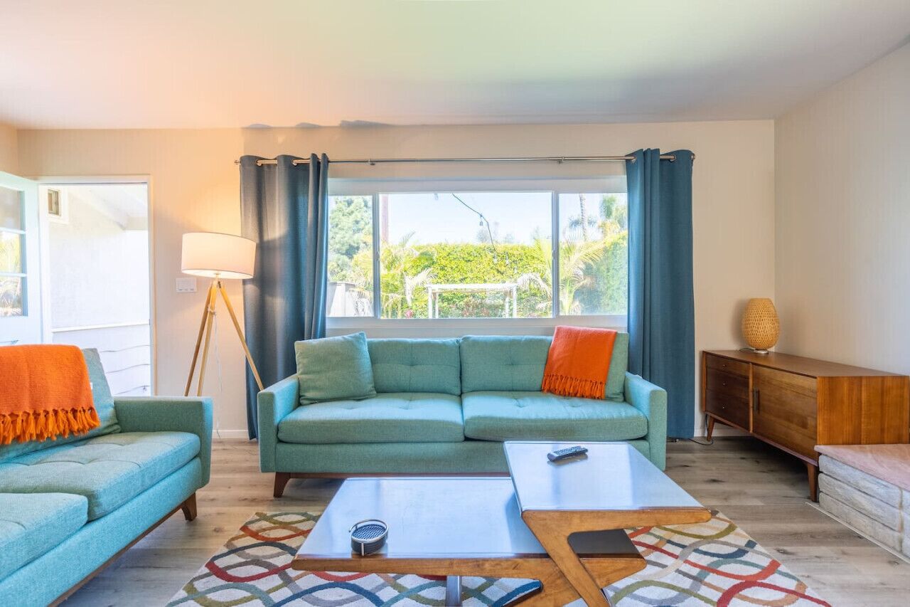 A living room with a sofa, coffee table, and a lamp.