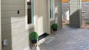 A house with a light-colored exterior, a front door, two windows, and a welcome mat. - Family friendly Grover Beach house located blocks from the ocean.    (Grover Beach)