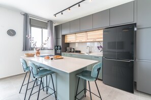 Apartment | Private kitchen | Full-size fridge, microwave, oven, stovetop - Sunlit Balcony & Coastal Charm by Sea N' Rent (Nahariya)