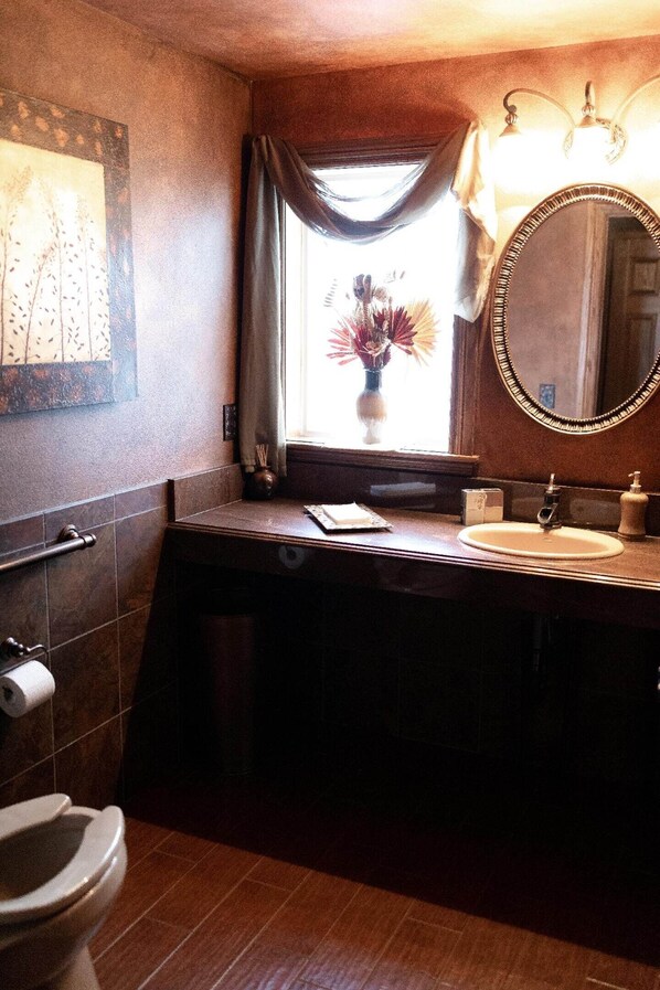 A bathroom with a toilet, sink, mirror, and window with curtains. - Full building no cleaning fee everythings close (Lake Geneva)