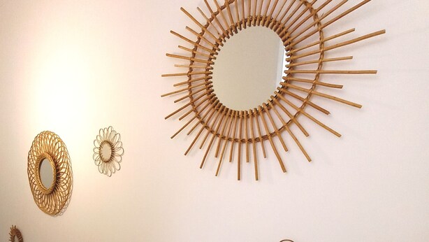 A wall with various circular and sunburst wall art pieces. - HISTOIRE DE LOIRE - La Maison (Saumur)