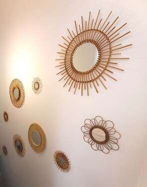 A wall with various circular and sunburst wall art pieces. - HISTOIRE DE LOIRE - La Maison (Saumur)
