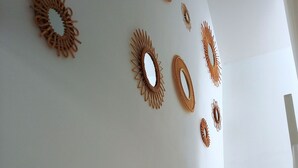 A staircase with a white railing and a wall decorated with circular wall art. - HISTOIRE DE LOIRE - La Maison (Saumur)
