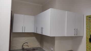 Fridge, stovetop, cookware/dishes/utensils, dining tables