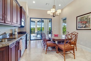A modern kitchen with dark wood cabinets, a granite countertop, and a built-in oven.