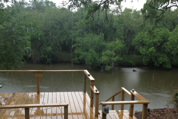 Large deck overlooking river. Private fishing dock down the stairs.