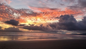 A beach with a sunset and clouds. - Tranquil apartment near beach front  (Playa Zancudo)