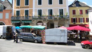 A building with a sign reading "LES PYRÉNEES" and "PIELLENIA HOTEL".